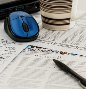 a mouse, documents, and a pen